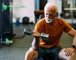 Older adult practicing resistance training for bone density and muscle mass.
