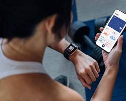 A person checking their health metrics on a modern smartwatch wearable device.